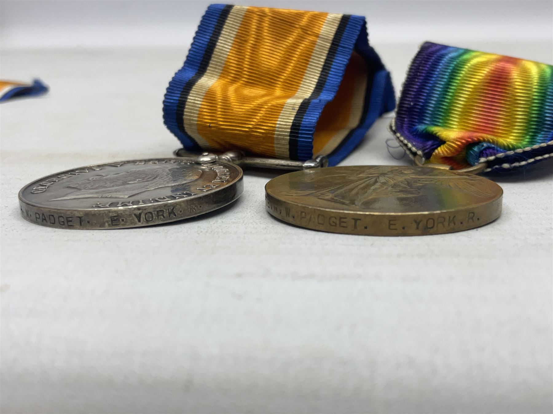 Family group of five WW1 medals for the East Yorkshire regiment comprising trio of 1914-15 Star, British War Medal and Victory medal awarded to 13-368 Pte. C. Padget; and British War Medal and Victory Medal to 201829 Pte. H.W. Padget; all with ribbons (5)