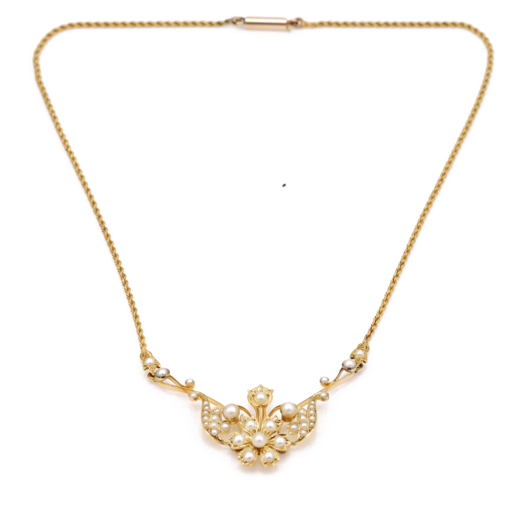 Edwardian gold pearl floral necklace, the openwork stylised floral and scroll mount set with split and seed pearls, to a rope twist chain necklace, in a tooled leather and blue velvet box