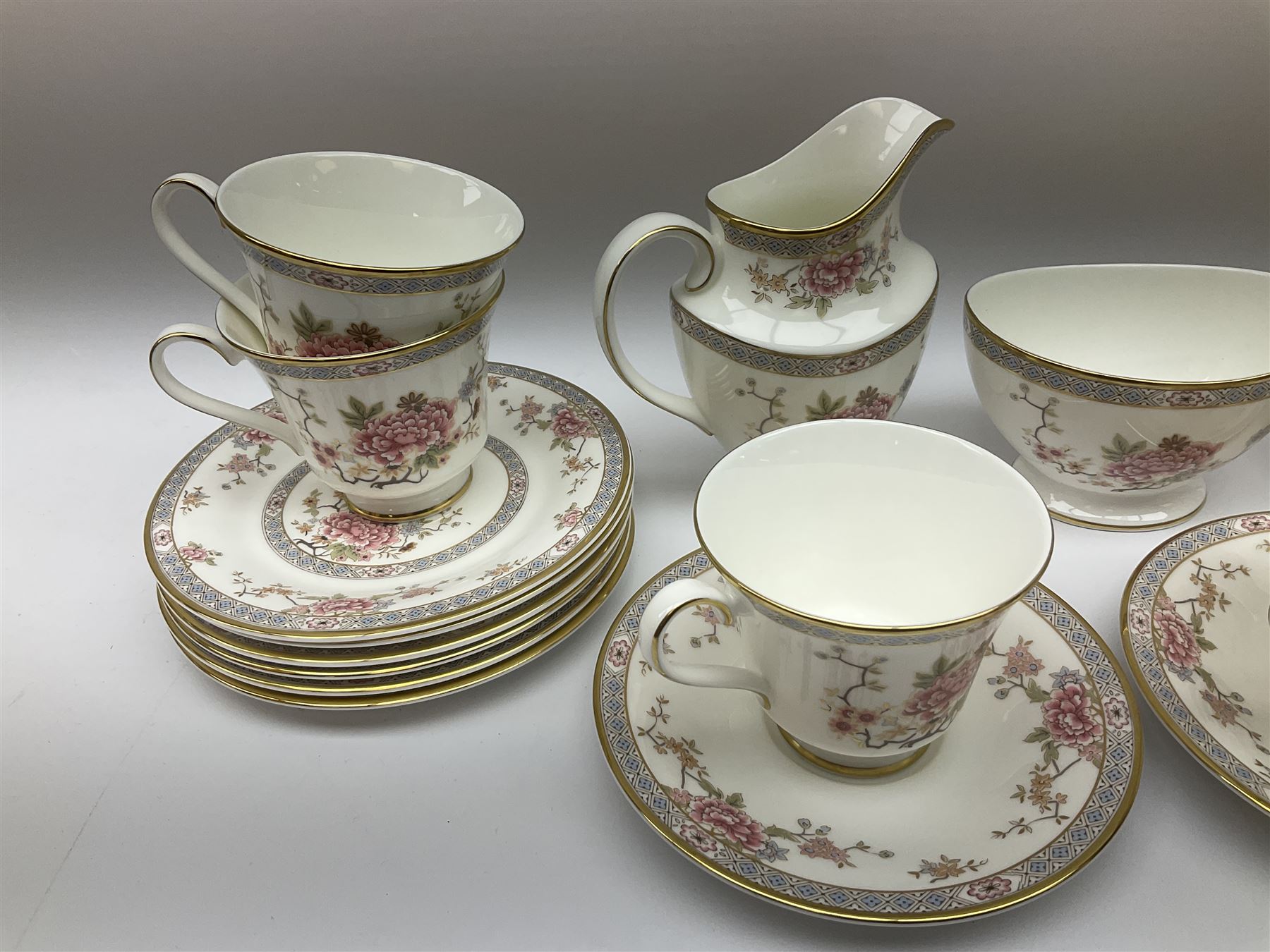 Wedgwood Queens Ware tea and dinner wares in Provence pattern, including ten cups and saucers, milk jug, butter dish with cover, ten dinner plates, ten bowls and ten side plates etc (71), together with Royal Doulton tea wares in Canton pattern, comprising six cups and saucers, milk jug, open sucrier and six dessert plates.    