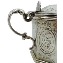 Victorian silver mustard pot, of octagonal form with bright cut engraved decoration and scroll handle, the slightly domed cover with scroll decorated thumbpiece lifting to reveal a later blue glass liner, hallmarked Henry Holland, London 1855, H7.5cm, approximate weight excluding liner 5.33 ozt (166 grams)