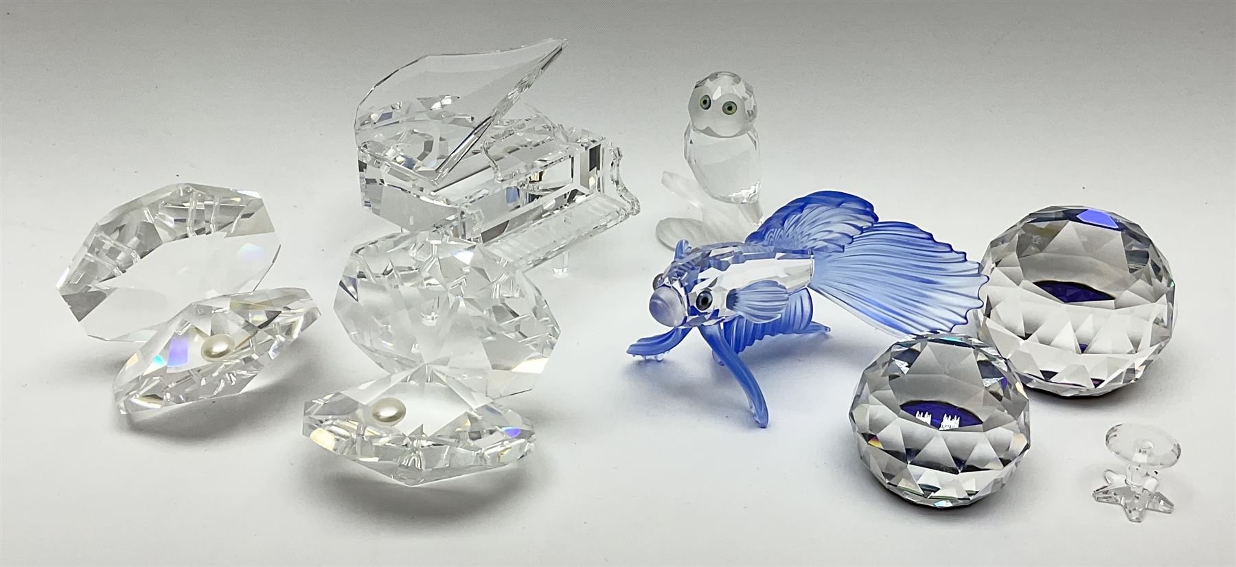 Six Swarovski crystal models, comprising an example modelled as a  Siamese fighting fish, two examples modelled as oyster shells with pearls, another modelled as a piano, plus a York Minster paperweight, Beverly Minster paperweight, and a Crystal Reflections model of an owl. 