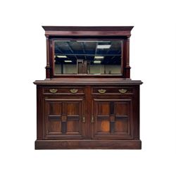 Victorian mirror back press, the arched corniced mirror back flanked by half columns, the base fitted with three drawers and four moulded panel doors with geometric detail, on a block plinth