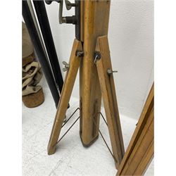 Three wooden adjustable tripods for plate cameras, together with a Linhof of Munchen metal tripod in a canvas case 
