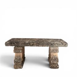 Weathered cast stone three-piece garden bench, with rectangular seat with egg-and-dart moulded edge, raised on end supports decorated with S-scrolls and fruiting vines