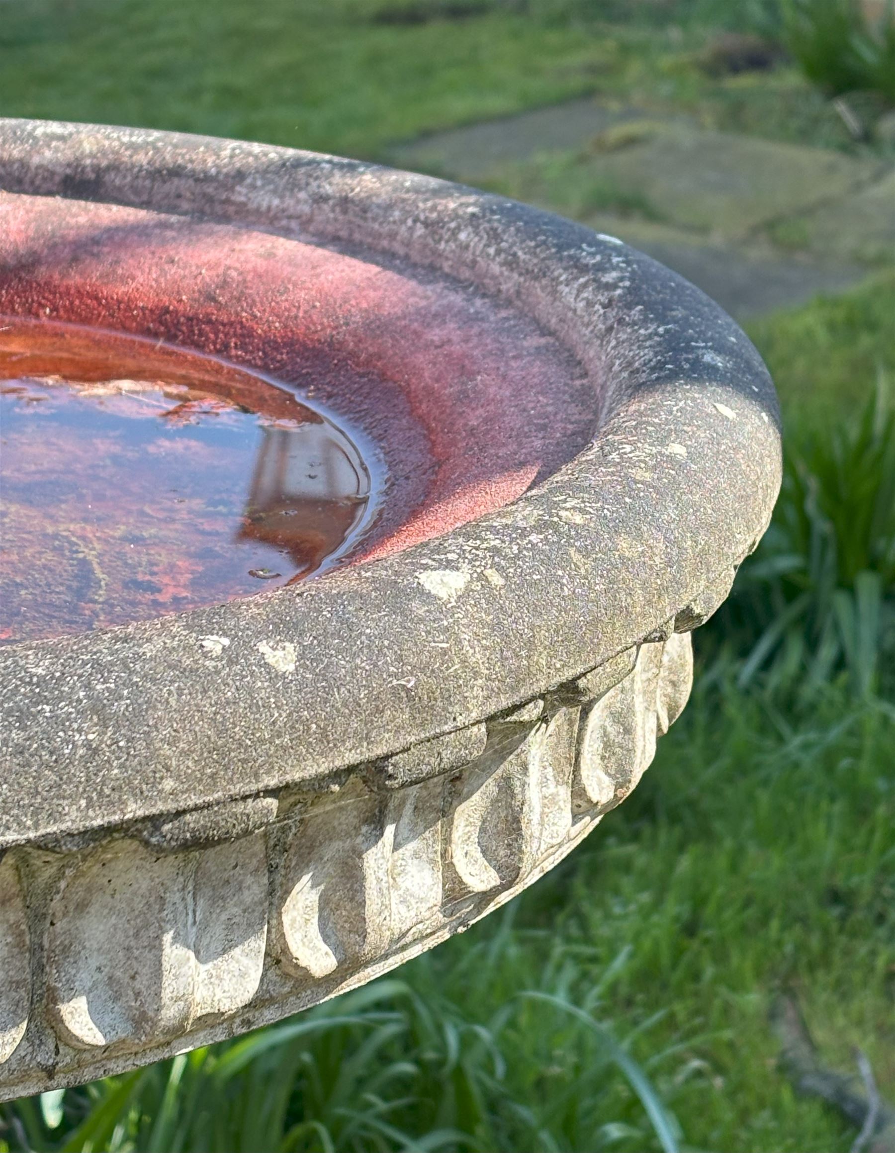 Reconstituted stone garden bird bath, the circular top with moulded waterleaf design on a pedestal decorated with floral motifs. H87cm, D59cm. - COLLECTION BY APPOINTMENT FROM: The White House, Thirsk Road, Easingwold, York, YO61 3NF - CALL 01723 507111 TO ARRANGE