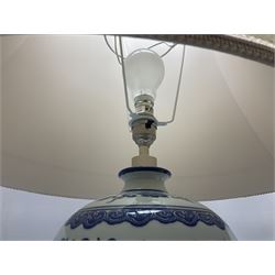 Two blue and white oriental style table lamps, both upon wood bases with matching fabric shades, tallest 33cm excl fitting