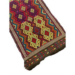 Flatweave geometric design rug, decorated with trailing hooked medallions within zig-zag bands, bright multi-coloured ground 