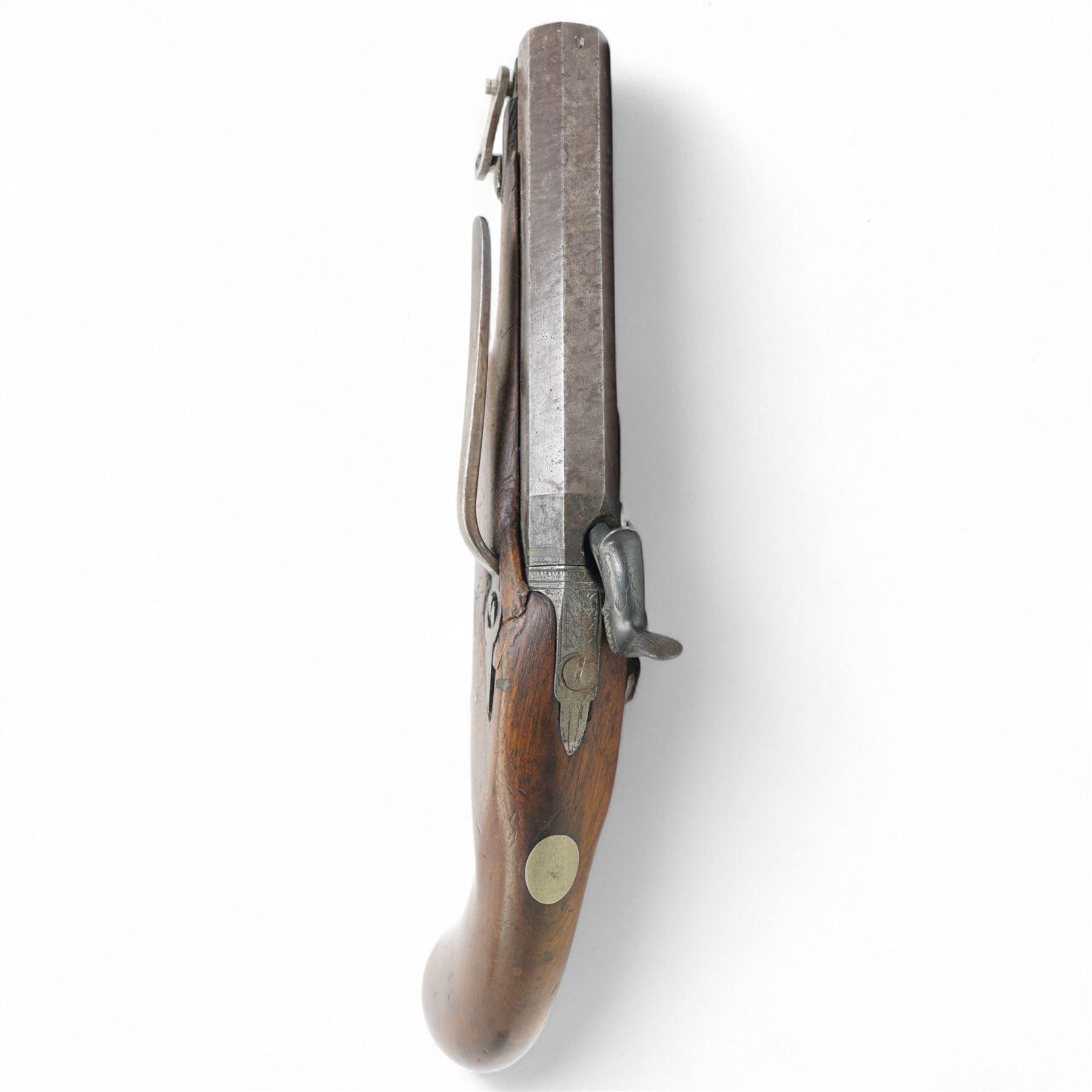 19th century percussion pistol with octagonal barrel, captive ramrod, belt hook, scroll engraved lock and trigger guard and walnut stock L25cm  