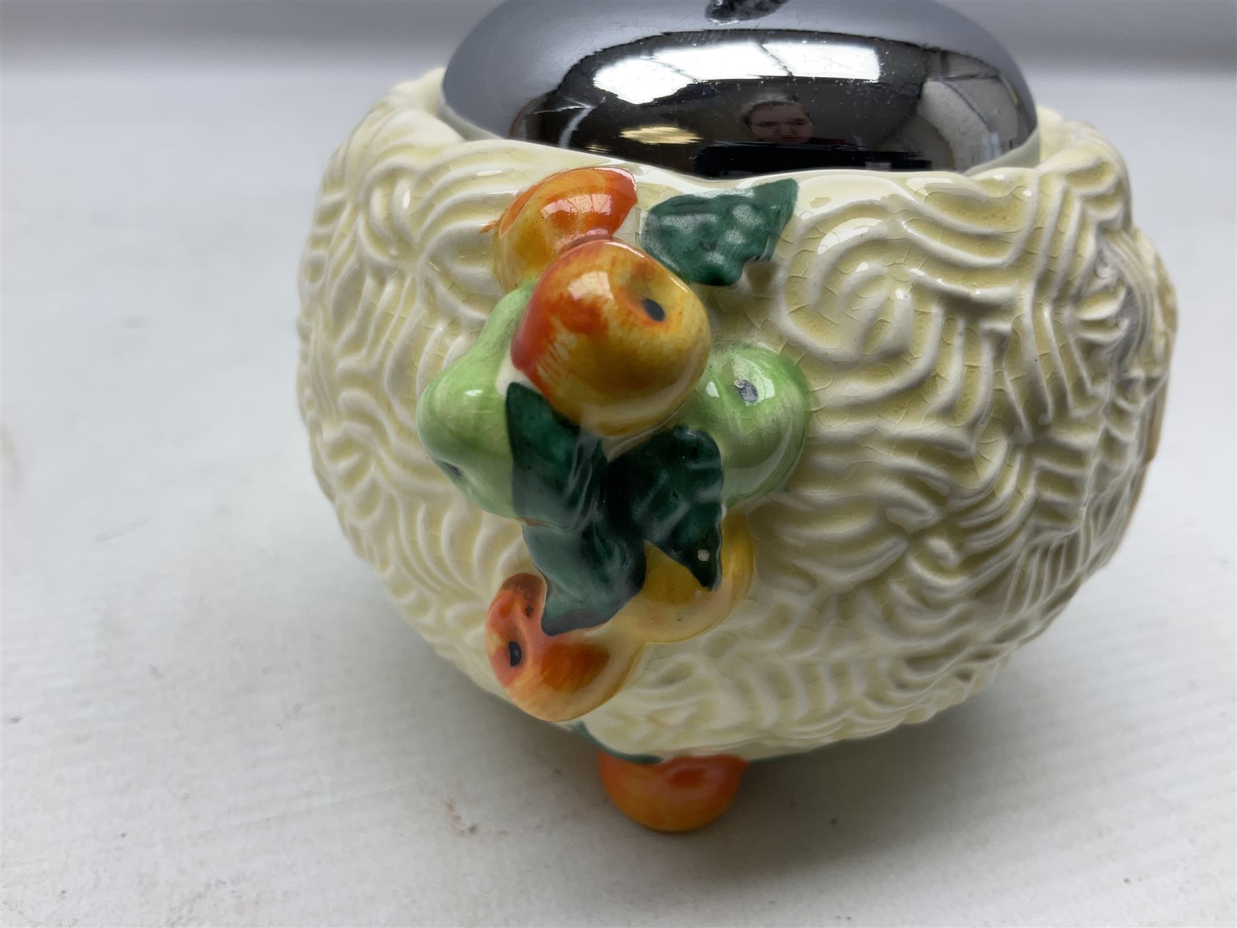 Clarice Cliff Celtic Harvest pattern sugar bowl, with original silver plate cover upon basket weave effect spherical body decorated with raised stylised fruit, H11cm