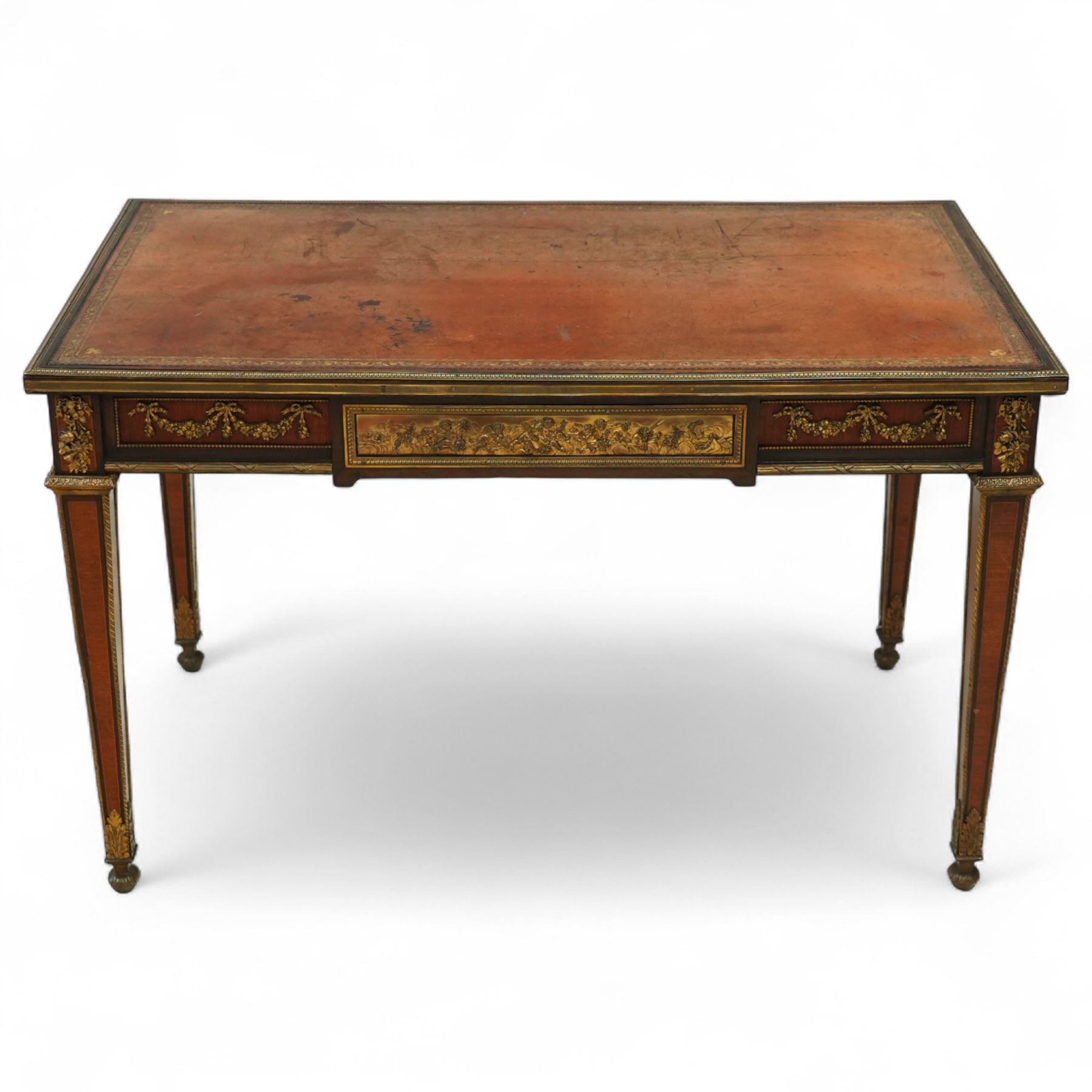 Fine 19th-century Louis XVI-style mahogany and gilt bronze-mounted writing table, rectangular top with a gilt tooled tan leather writing surface within a moulded gilt bronze edge above a frieze fitted with three drawers, mounted with floral and foliate gilt bronze swags  and borders, raised on square tapering legs with acanthus mounts and toupie feet