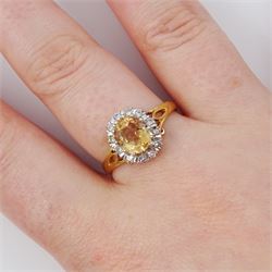 18ct gold imperial topaz and diamond cluster ring, oval cut topaz of approx 1.50 carat, surrounded by twelve round brilliant cut diamonds, London 1987, total diamond weight approx 0.10 carat