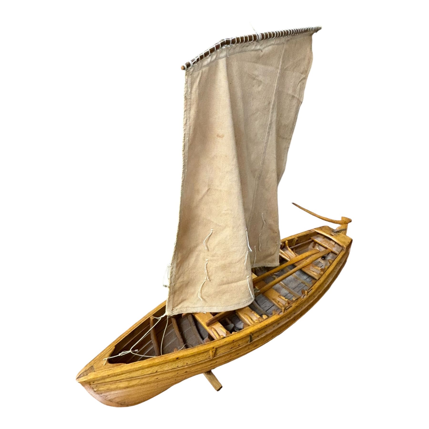 Wooden model of a fishing coble, with single canvas sail, upon a rectangular wooden plinth, total H74cm