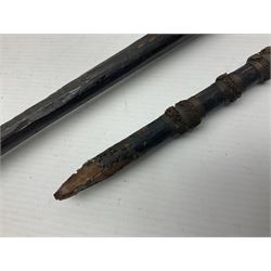 Native hand forged iron fishing spear, the V-shaped head with barbed neck and hewn haft L171cm; and two other hand forged iron spear heads, one with remains of copper bound haft (3)