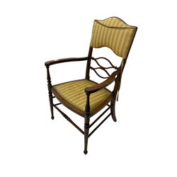 Edwardian inlaid mahogany elbow chair, centre pail pierced and shaped, back and seat upholstered in striped yellow fabric, turned supports