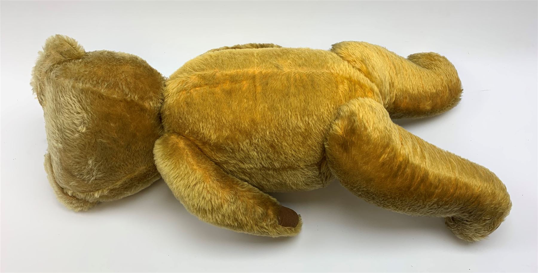 Very large Irish Tara bear c1950s with plush covered body, swivel jointed head with glass eyes and vertically stitched nose and mouth, jointed limbs with rexine pads and growler mechanism H37