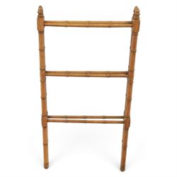 Victorian simulated bamboo two section towel rail, with turned brass capped finials, with three rails for hanging, hinged at one side