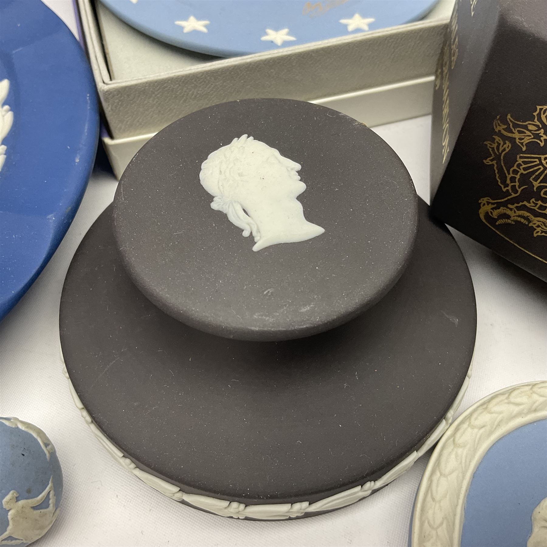 Collection of Wedgwood Jasperware, to include black Eisenhower Bust, two black basalt paperweights, one depicting an eagle and one depicting Julius Caesar, a blue Zodiac plate, Man on the Moon commemorative plate, American Independence Bicentennial plate and Royal commemorative ware, etc, all with impressed marks beneath, some with boxes