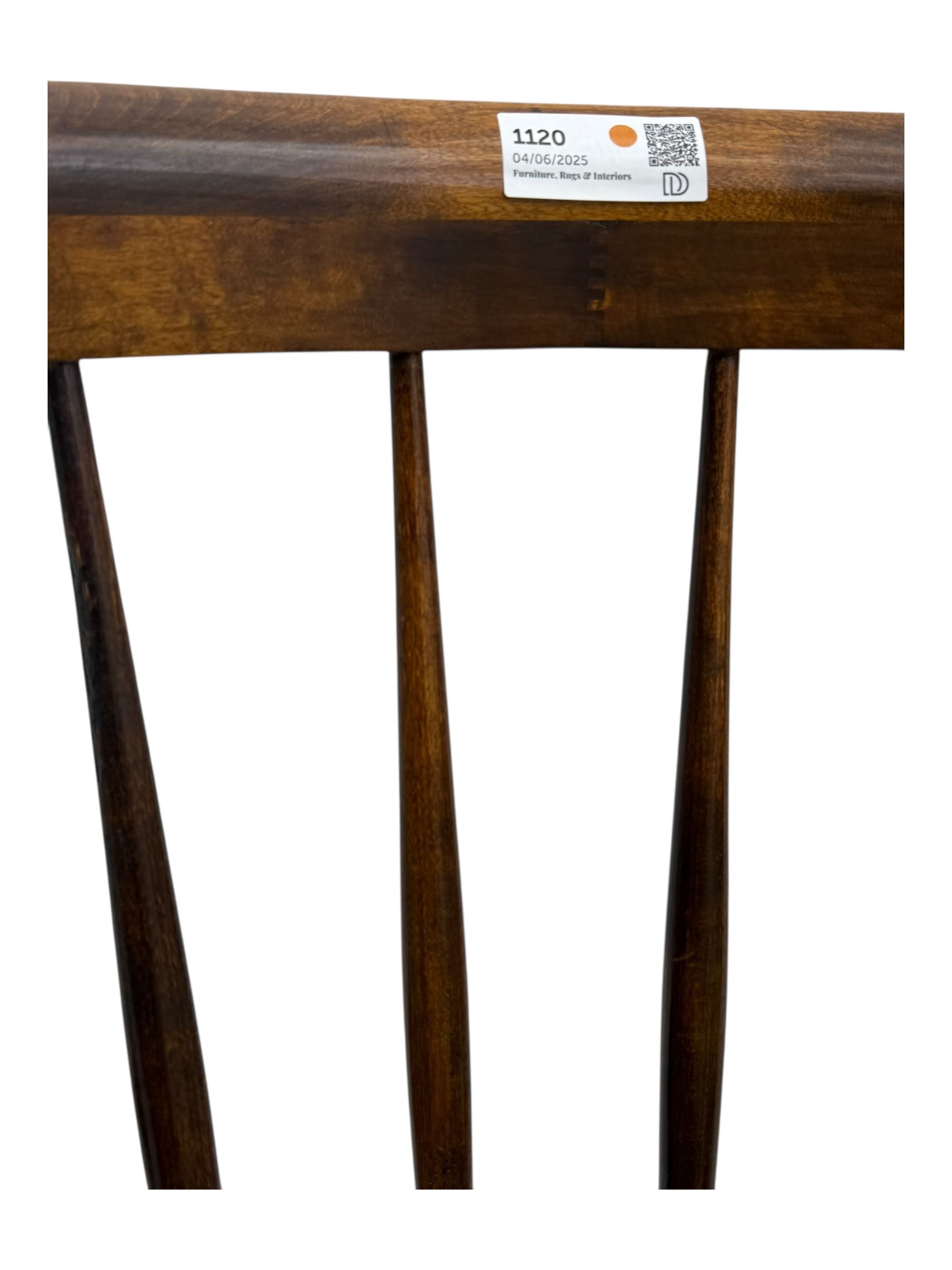 Late 19th century elm and beech Windsor rocking chair, with shaped top rail over turned spindles and curved arms, circular seat raised on turned legs united by stretcher on rockers