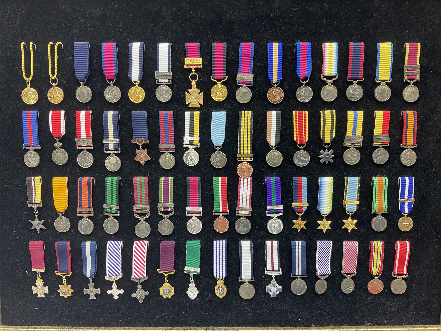 Two limited edition large framed display boards with half-size copies of British Gallantry and Campaign Medals produced by Danbury Mint and entitled 'For Valour'. Sixty medals on each board, all with ribbons. Complete with Danbury Mint certificate serial number A0148 and other paperwork.