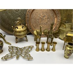 Two Eastern brass chargers, chased with Deities and figures, and foliate and diaper type borders, each approximately D57cm, together with an Eastern copper plate with pierced rim, embossed with a figure and zoomorphic creature, D38cm, and other brassware including small pair of Japanese Meiji period vases, Eastern flask, koro with foo dog finial to the cover, two large trivets, one example with folding top, etc. 