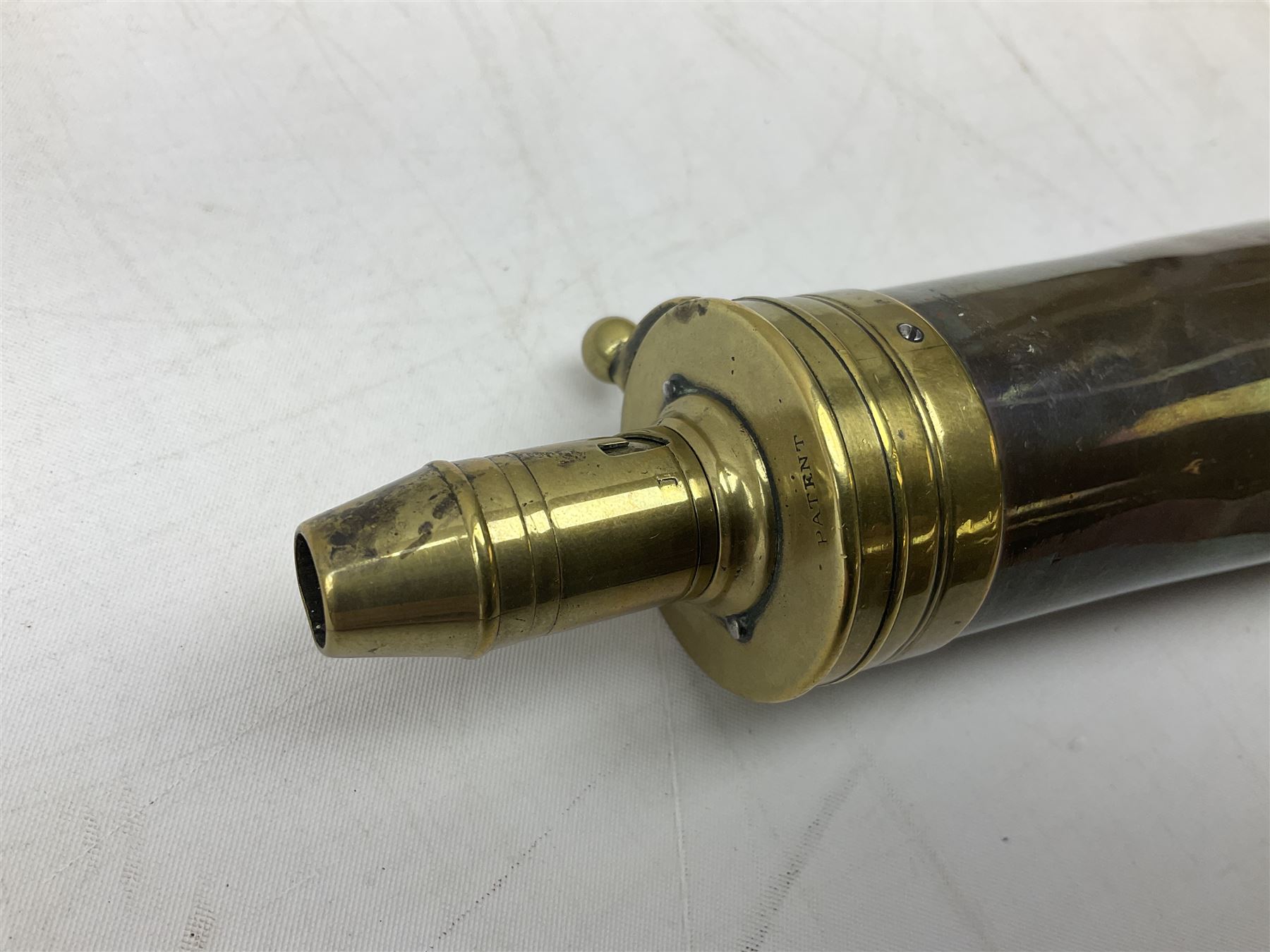 Two Sykes Patent brass mounted small load powder flasks with fire proof safety tops - one with slim plain copper body H17.5cm; the other with plain gun metal body H19cm (2)