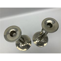 Archibald Knox (1864-1933) for Liberty & Co, pair of Tudric pewter candlesticks, the bud shaped sockets raised upon three angular fin supports and a slightly domed circular base with cast stylised foliate decoration, each stamped beneath Tudric 0223, H30cm