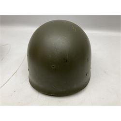 American first type paratrooper helmet with post-WW2 strap and D-rings and later 1944 liner bearing Firestone Tyre and Rubber Company mark; green textured finish