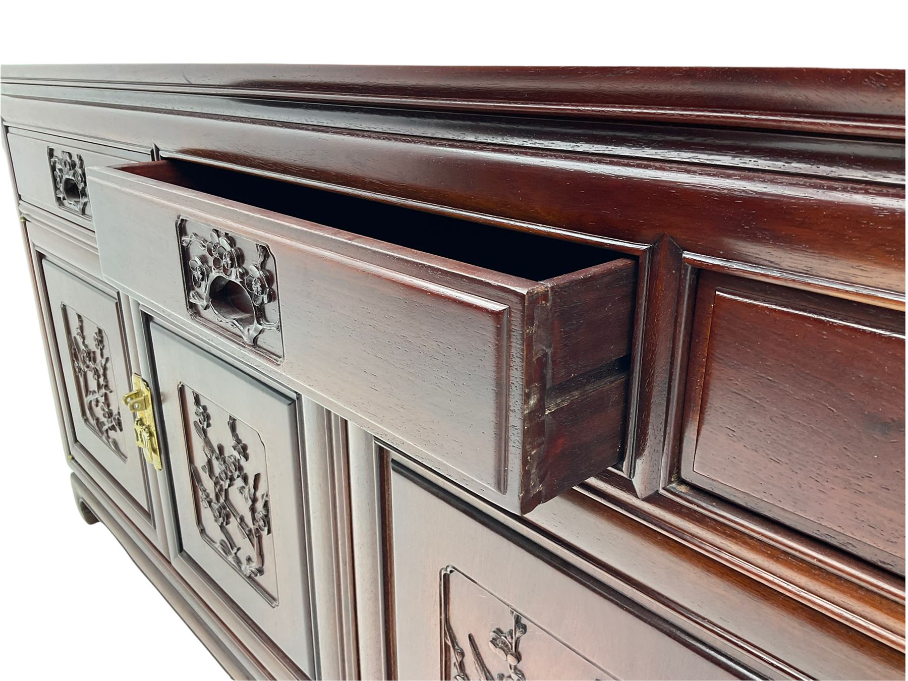 Chinese hardwood sideboard, three drawers above four cupboards, the doors relief carved with flowers and birds 