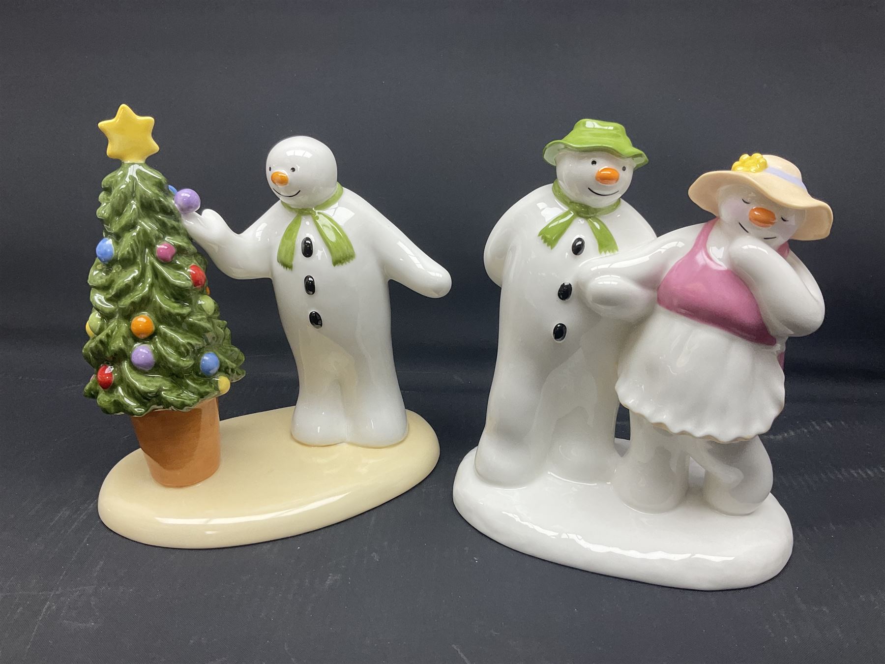 Four Coalport Characters The Snowman figures, comprising Snowman's Surprise, Christmas Cheer with certificate, The Bashful Blush and Dancing at the Party, all with original boxes 