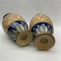 Pair Doulton Lambeth Slaters Patent vases of ovoid form, decorated with a floral and gilt band upon a dark blue ground, with impressed marks beneath, approx H34.5cm