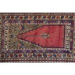Persian Qashqai prayer rug, traditional tribal palette of red, indigo blue ivory and ochre, central field with stepped mihrab design in red, cantered by a stylized hanging lamp framed by a moss green spandrels, framed by boteh and floral motifs within multiple borders including an ivory border decorated with stylized animals in alternating colours 