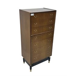 G-Plan teak tallboy, seven drawer chest with brass loop handles, ebonise base with adjustable brass terminals