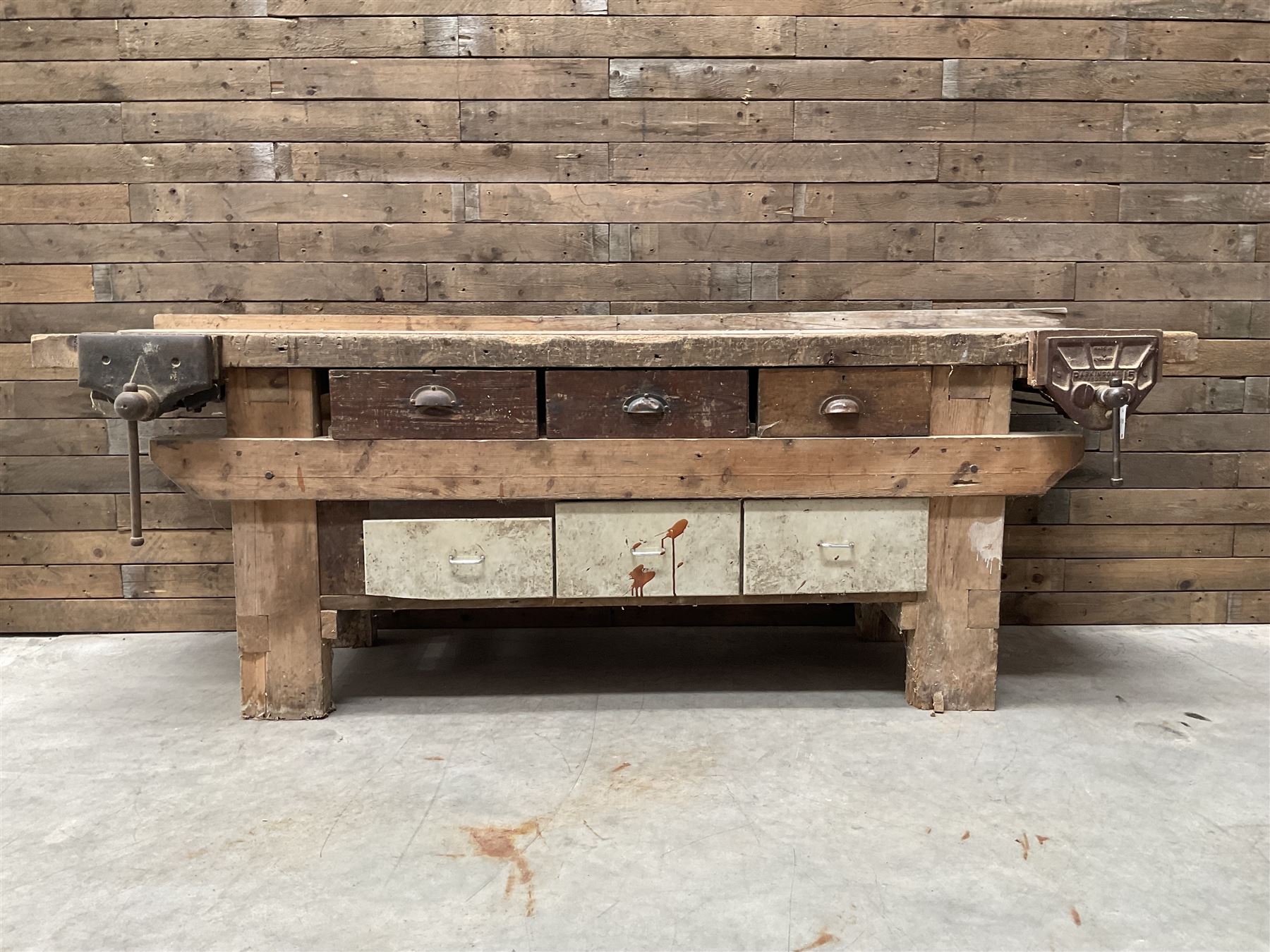 Large vintage work bench, fitted with six drawers and two vice