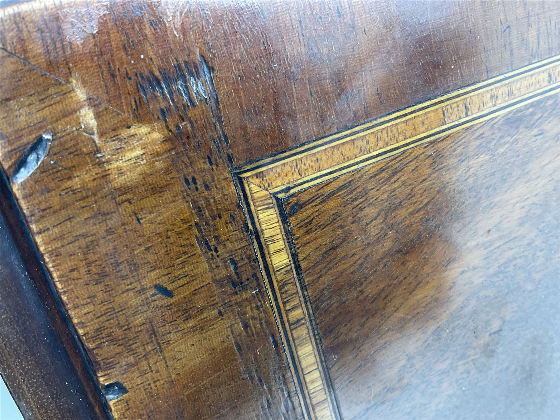 George III mahogany bureau, the conch inlaid fall front enclosing pigeon holes, shelves and central cupboard with inlaid flower motif, four graduating cock-beaded drawers below each with brass handles, lower moulded edge over shaped bracket feet