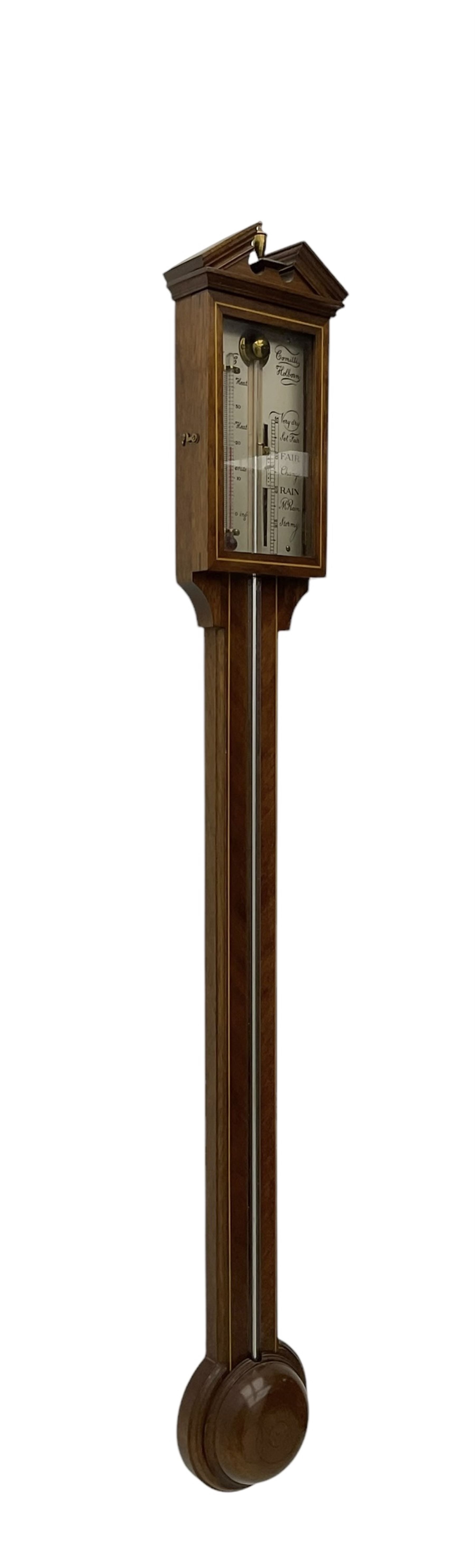 Comitti-20th century mercury stick barometer in an 18th century style mahogany case with satinwood stringing, with a broken pediment, brass finial and round base, silvered register with recording vernier, weather predictions and a centigrade/Fahrenheit spirit thermometer enclosed within a glazed door, visible tube with a bulb cistern and turned mahogany cover.
Mercury clean and present with no air locks.
