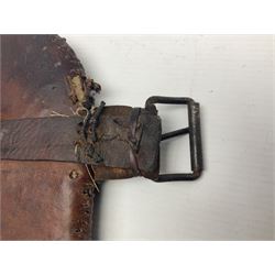 Eastern Jambiya, the 19cm double edge steel blade with raised medial ridge, waisted horn grip with pique work and white metal band; in stitched leather scabbard L33cm overall
