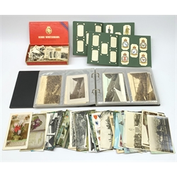 Approximately one hundred and forty postcards, most of local interest depicting Saltburn by the sea, a number depicting Nottingham, an example depicting the Gresley Pacific Mallard locomotive, together with a selection of Inter War cigarette cards, largely Cavanders examples, and two albums containing Players RAF Badges, and Uniforms of the Territorial Army. 
