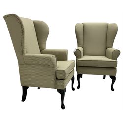 Pair of Queen Anne design wingback armchairs, traditional shape with rolled arms, upholstered in fan patterned fabric, raised on ebonised cabriole supports