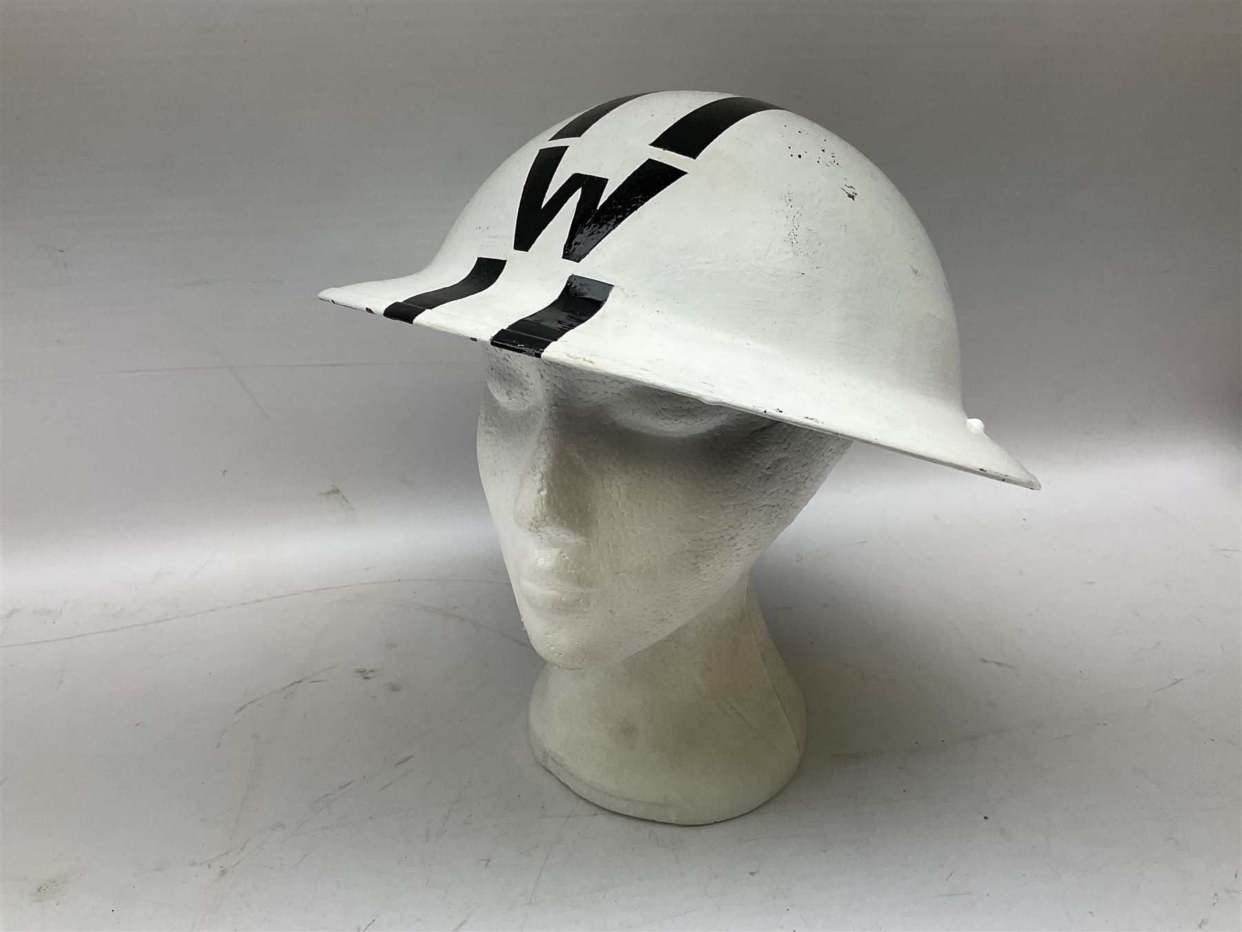 WW2 Home Front 'Police' black painted steel helmet with original liner and webbing chin strap, impressed R.O. Co. 1/1939; and re-painted shell only for WW2 Wardens steel helmet impressed AMC II 1941 C676 (2)