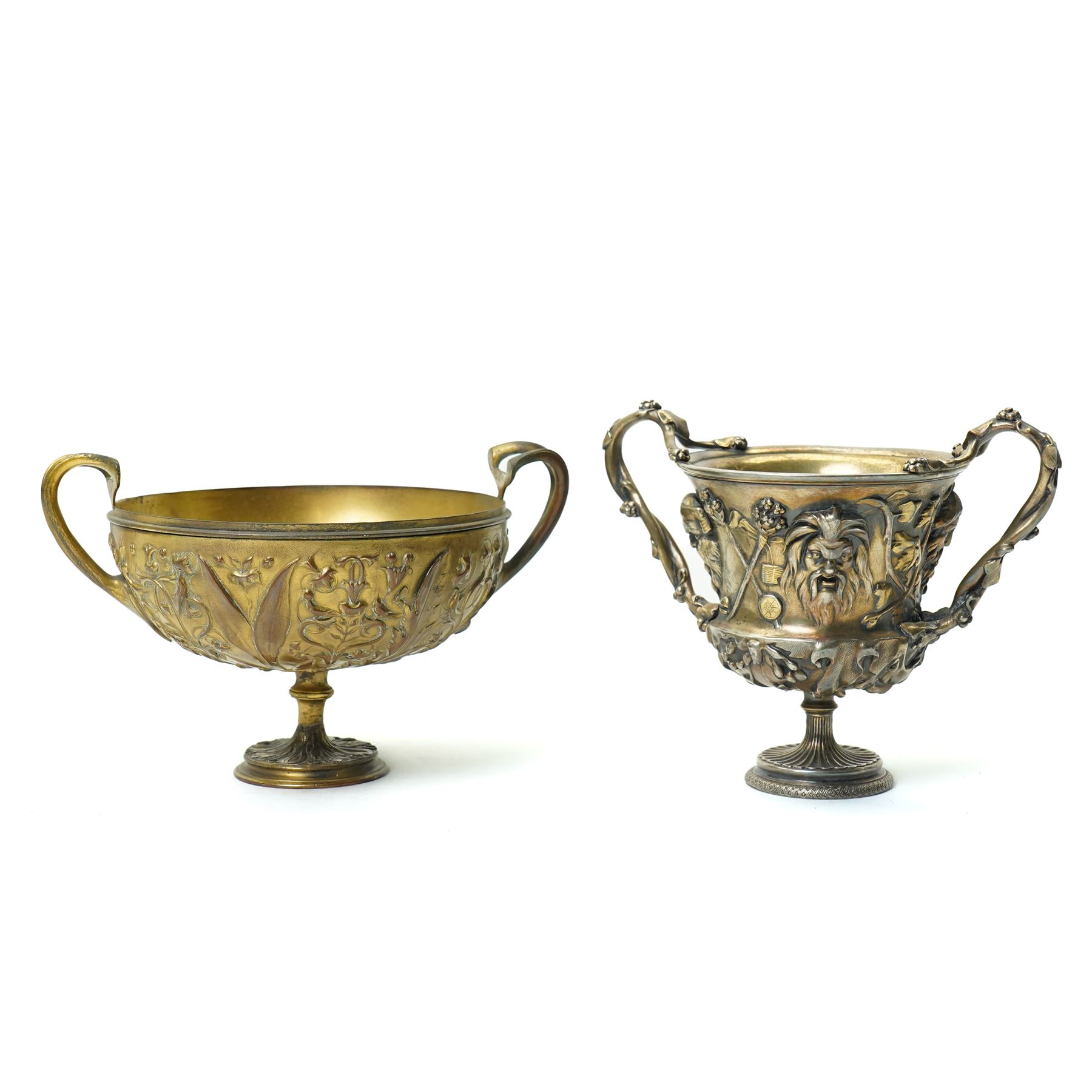 Christofle 'Tresor d'Hildesheim' facsimile gilt metal two handled cup decorated with masks, leaves etc H13cm and a bowl from the same collection with two handles and a raised pattern of leaves on a pedestal foot D19cm (2) 