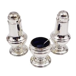 Modern silver three piece cruet set, comprising salt shaker, pepper shaker and mustard pot and spoon, all of slightly waisted form and upon circular stepped foot, hallmarked Laurence R Watson & Co, Birmingham 2001, boxed 