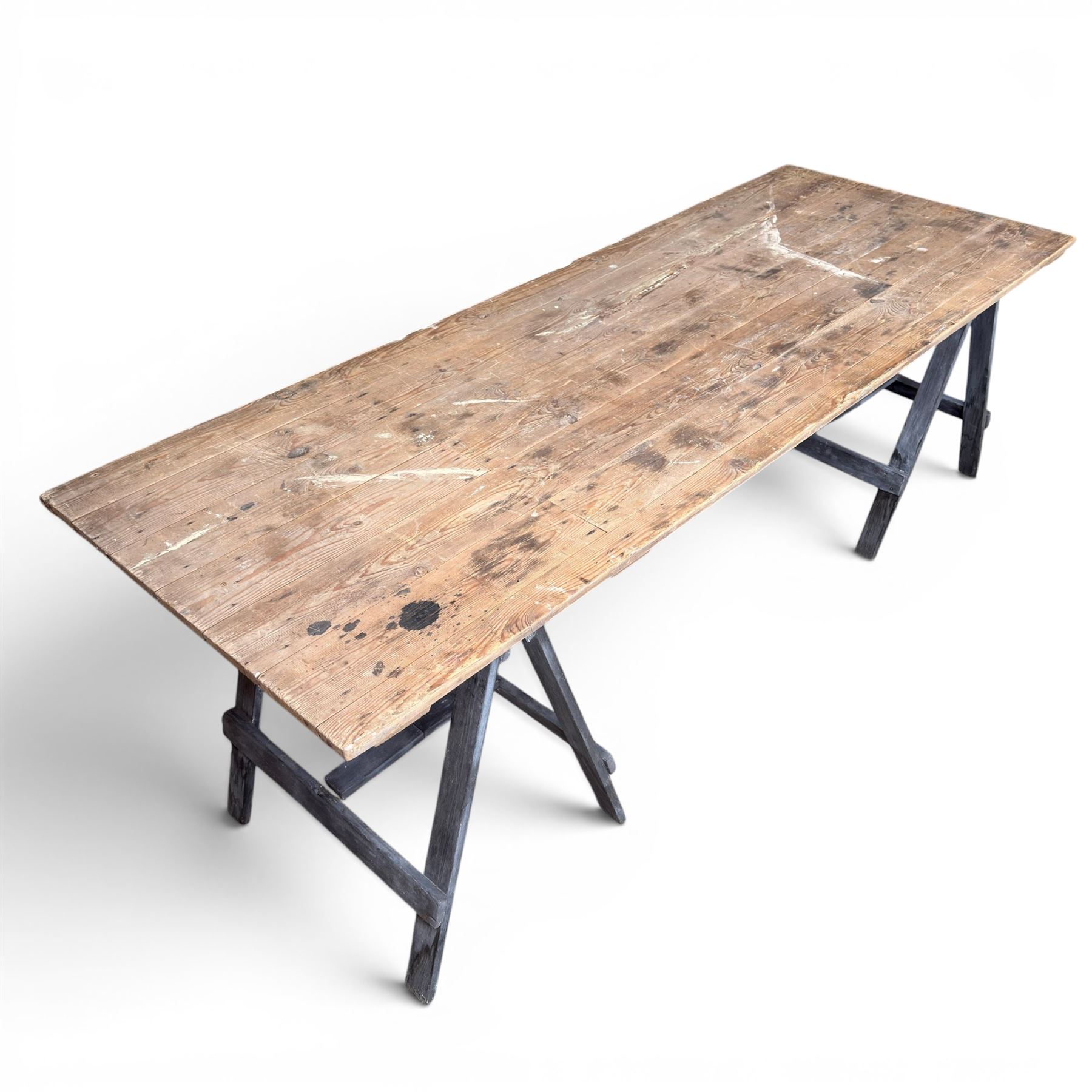 Vintage wooden plank trestle table, on two painted folding stands