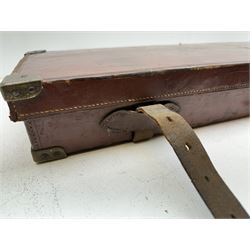 Leather and brass mounted gun case, twin leather straps and carry handle, marked T.E.S to the top, opening to reveal red baize lined interior with trade label Rowland Watson, Gunmaker, 17 Whittall Street, Birmingham, to take 76cm (30