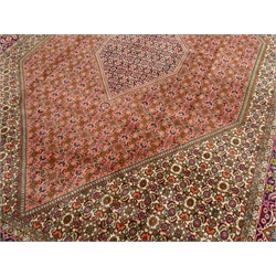  Persian Bijar rug carpet, central lozenge within larger lozenge, all over Heratti motif decoration, five band border with stylised flower heads and scrolls, 350cm x 250cm  