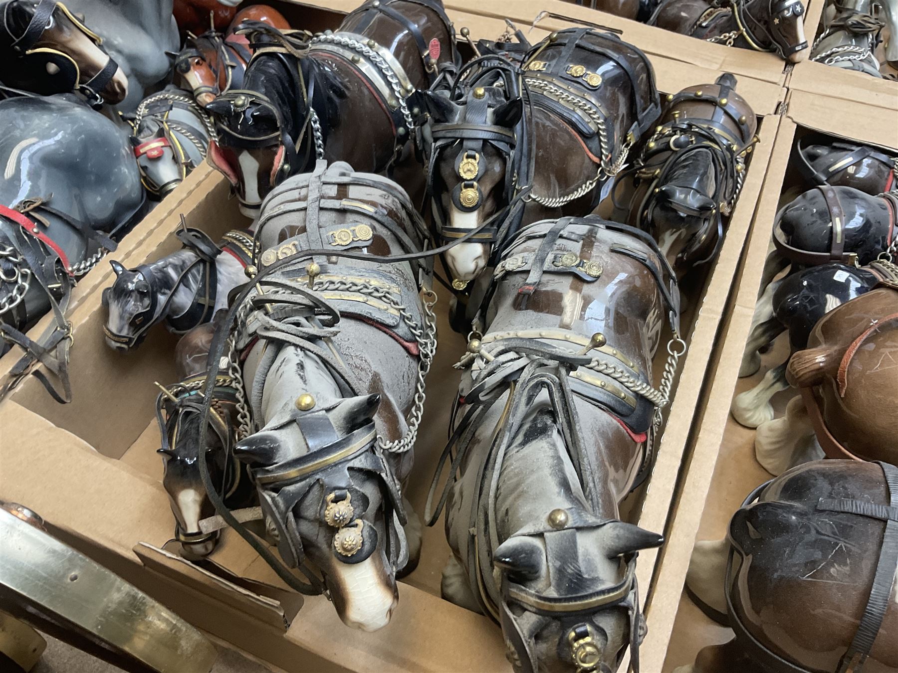 Approximately forty seven ceramic Shire horses to include Sylvac and Melba Ware examples of various sizes and colours, many with harnesses, and a quantity of carts and wagons 