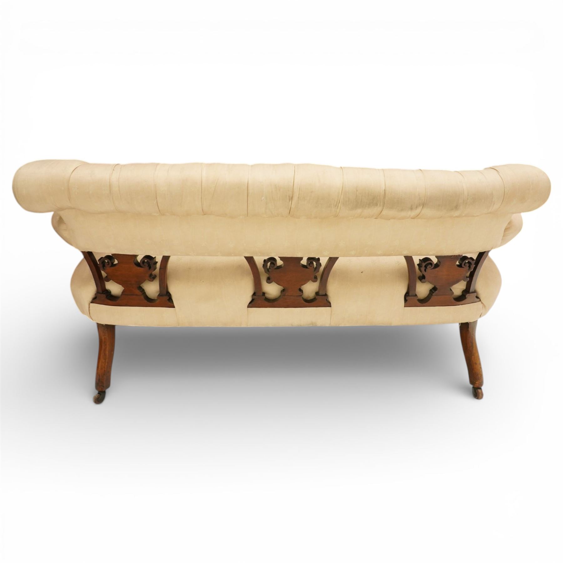 Edwardian inlaid mahogany sofa, upholstered in cream fabric with buttoned back rail, tapering legs on brass castors