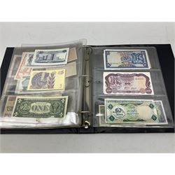 World banknotes, including Queen Elizabeth II The States of Jersey one pound 'DB202703', five pounds 'BB527762' and ten pounds 'AB651481', reserve bank of New Zealand two dollars '1L3 741894', King George V Straits Settlements one dollar 1st January 1935 'F/83 28924', various Bank of England notes etc, housed in two ring binder albums