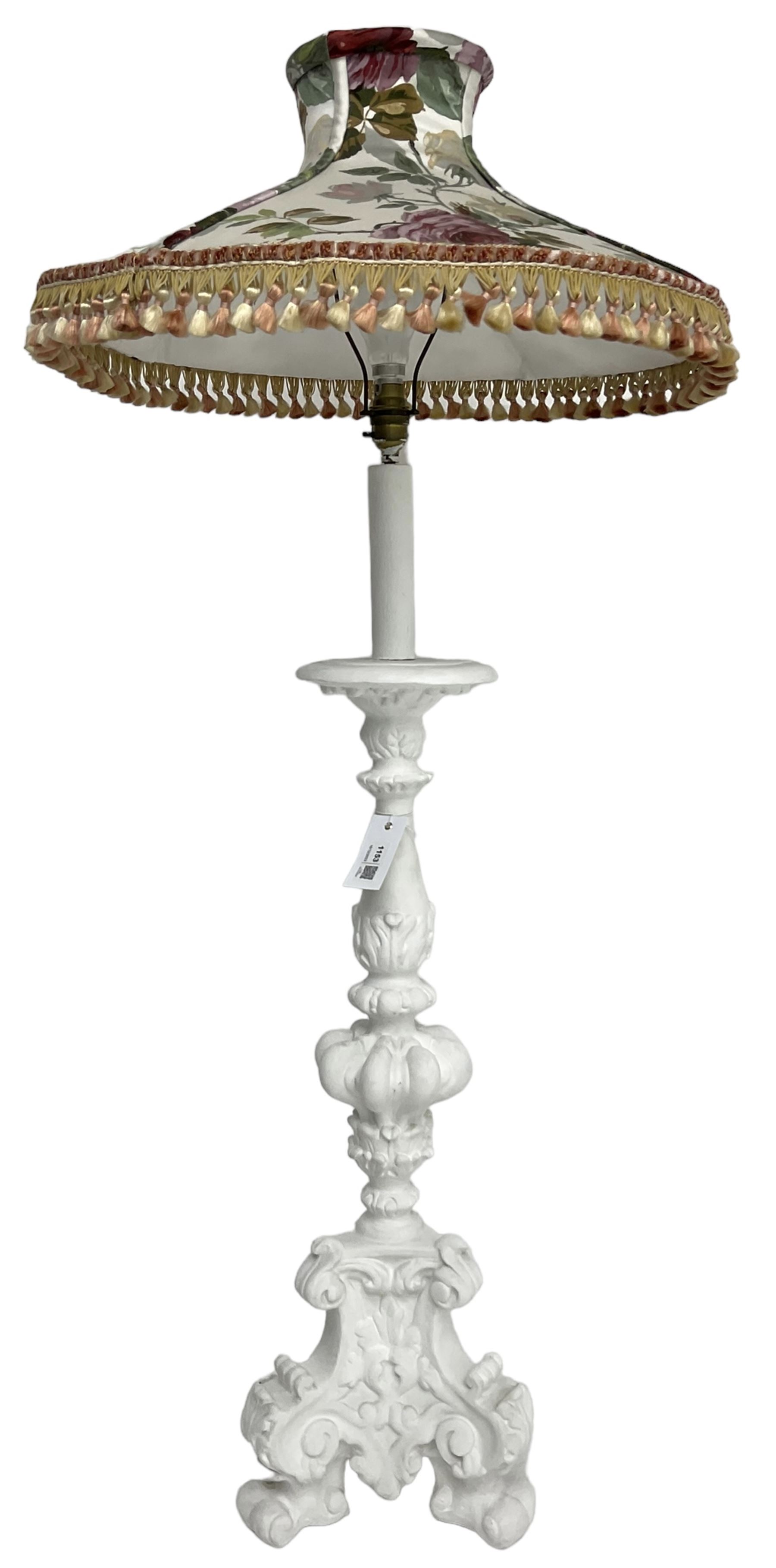 White painted Italian Baroque design standard lamp, ornately cast with foliage and scrolls, on three scrolled feet, with floral shade