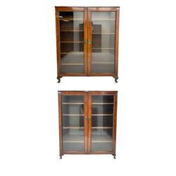 19th century mahogany bookcase display cabinet, two glazed doors enclosing four adjustable shelves, raised on cabriole feet (W123cm D34cm H146cm); together with another similar (W116cm D29cm H142cm)