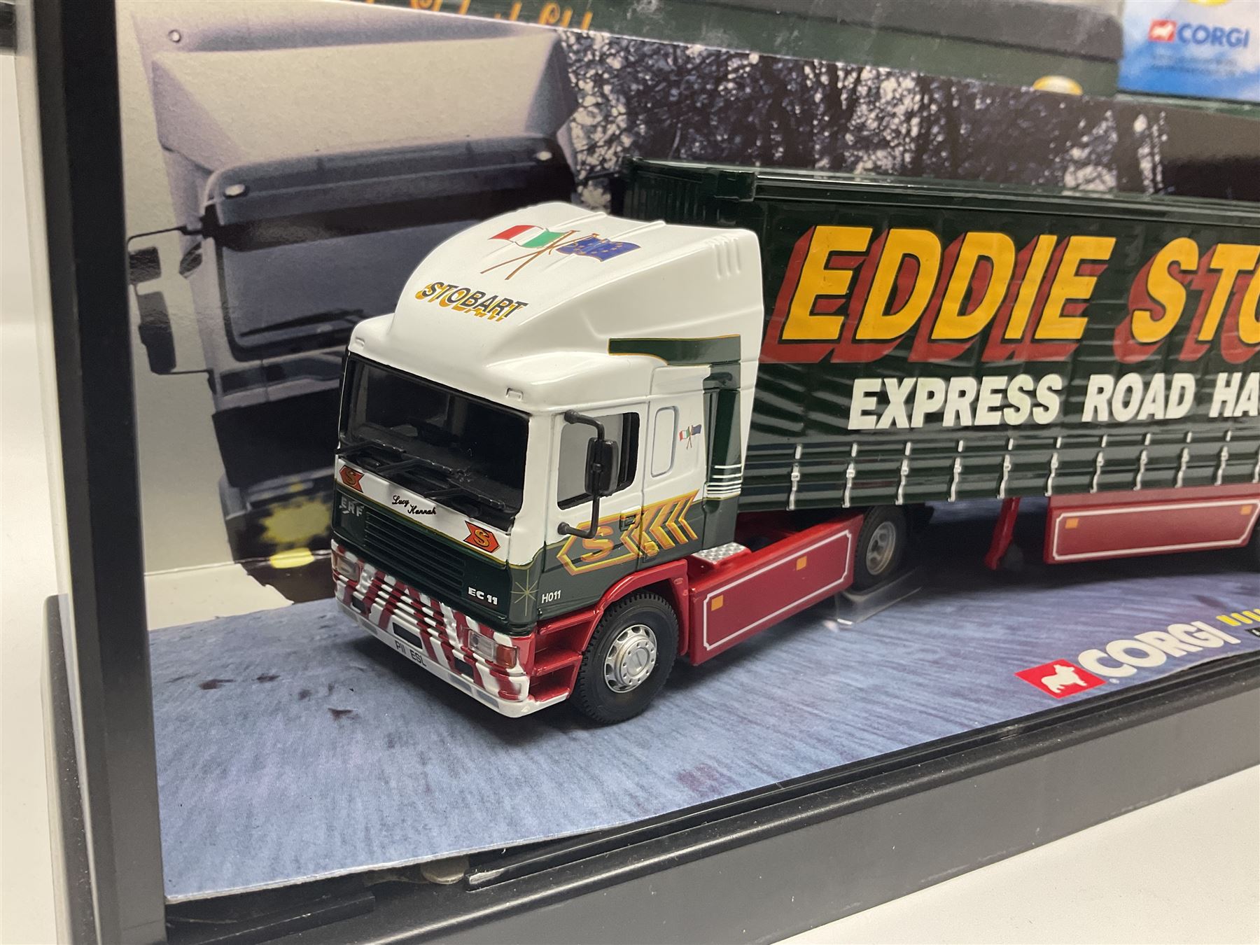Corgi Eddie Stobart - four heavy haulage vehicles comprising 75201 ERF Curtainside; 75403 Leyland-DAF Curtainside; both in plastic display boxes; CC12610 Scammell Crusader 3 Axle Low Loader; and CC12502 Atkinson Borderer Flatbed Trailer; together with AA30008 Douglas DC-3 Aircraft; all boxed (5)